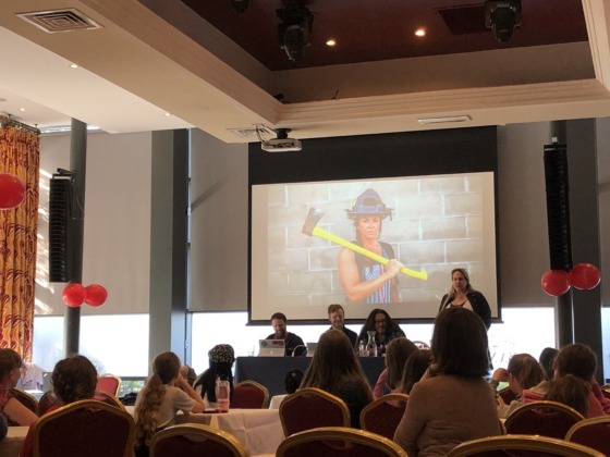 Brenda Romero, CEO of Romero Games, described the video game design process to her audience of aspiring game developers. For Brenda, being a game developer involves constant “firefighting” to put her vision into action.